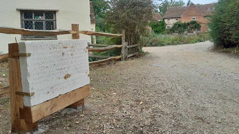 The Parkington commemorative stone with Flatford Mill beyond.